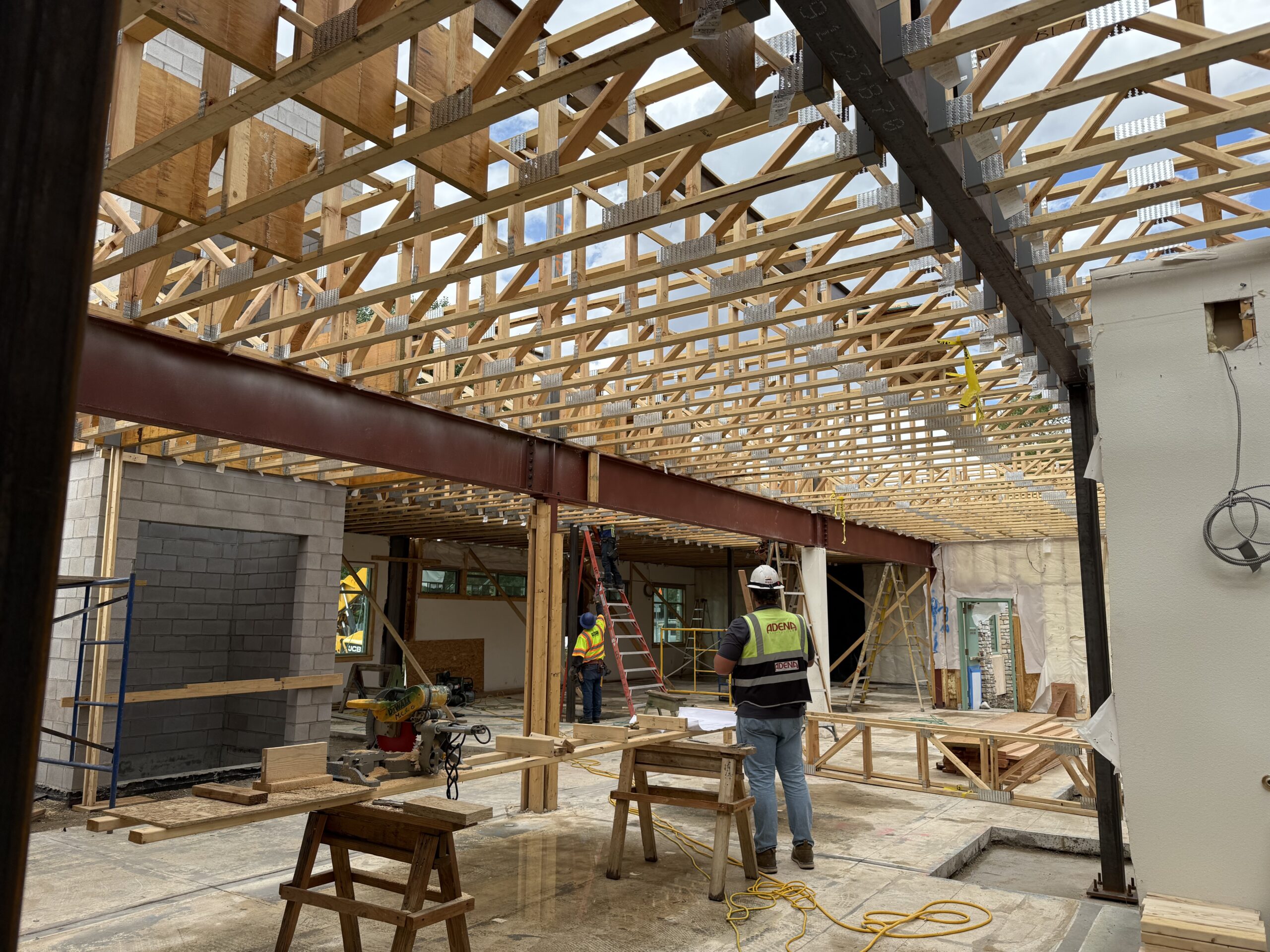 Wood trusses span frames to support the 2nd floor.